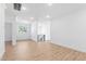 Open-concept living room with wood floors, white walls, and large windows for plenty of natural light at 162 Lookout Rdg # 677, Pittsboro, NC 27312