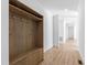 Hallway featuring a stylish wooden mud room cabinet with hooks and drawers next to the light wood flooring at 162 Lookout Rdg # 677, Pittsboro, NC 27312