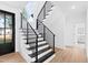 Elegant staircase with black metal railings and white risers leading to the upper level at 162 Lookout Rdg # 677, Pittsboro, NC 27312