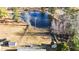 Aerial view of the backyard featuring a pond, playset, and mature trees at 186 Sunrise Dr, Sanford, NC 27332