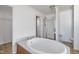 Bathroom with an oval tub, tiled floors, a shower, and neutral walls at 186 Sunrise Dr, Sanford, NC 27332