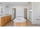 Bathroom with a large soaking tub, separate shower, and double vanities at 186 Sunrise Dr, Sanford, NC 27332
