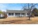 A front view of a cozy single-story home with a covered porch and classic black shutters at 186 Sunrise Dr, Sanford, NC 27332