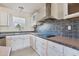A kitchen featuring light colored cabinets and updated fixtures at 186 Sunrise Dr, Sanford, NC 27332