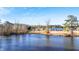 Beautiful view of homes across the lake on a sunny day with blue skies at 186 Sunrise Dr, Sanford, NC 27332