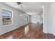 Bright living room with wood floors, multiple windows, and a ceiling fan at 186 Sunrise Dr, Sanford, NC 27332