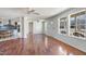 Bright living room with wood floors, ceiling fan, and large windows at 186 Sunrise Dr, Sanford, NC 27332
