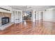 Open-concept living space featuring a cozy fireplace, hardwood floors, and access to the kitchen at 186 Sunrise Dr, Sanford, NC 27332
