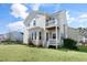 Charming home's rear exterior showcasing a second-story balcony and well-maintained lawn at 200 Gravel Brook Ct, Cary, NC 27519