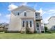 Charming home's rear exterior showcasing a second-story balcony and well-maintained lawn at 200 Gravel Brook Ct, Cary, NC 27519