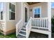 Inviting back porch with white railings and steps, offering a cozy outdoor space at 200 Gravel Brook Ct, Cary, NC 27519