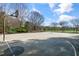Outdoor basketball court with hoops and benches in a community with mature trees and manicured landscaping at 200 Gravel Brook Ct, Cary, NC 27519