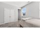 Bedroom boasts a double door closet, light gray walls, and neutral carpet flooring at 200 Gravel Brook Ct, Cary, NC 27519