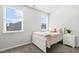 This bedroom offers two windows and a minimalist interior design with light gray walls at 200 Gravel Brook Ct, Cary, NC 27519