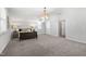 Spacious bedroom features neutral carpet, a tray ceiling, and soft, natural light at 200 Gravel Brook Ct, Cary, NC 27519