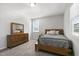Bedroom features a light wood dresser and bed frame with a large mirror and plush carpet at 200 Gravel Brook Ct, Cary, NC 27519