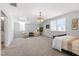 Spacious bedroom featuring neutral walls, carpet flooring, pendant lighting and two lounge chairs at 200 Gravel Brook Ct, Cary, NC 27519