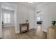 Bright entryway featuring hardwood floors, white trim, and a charming wooden console table with access to other rooms at 200 Gravel Brook Ct, Cary, NC 27519