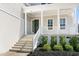 Inviting front porch features classic columns, a decorative wreath, and well-maintained landscaping at 200 Gravel Brook Ct, Cary, NC 27519