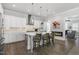 Open kitchen featuring a central island with bar stools, stainless steel appliances, and seamless flow into the living area at 200 Gravel Brook Ct, Cary, NC 27519