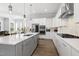 Modern kitchen with white cabinets, stainless steel appliances, and a spacious island with bar seating at 200 Gravel Brook Ct, Cary, NC 27519