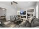 Spacious living room with modern fireplace, large TV, comfortable seating, and open access to dining and kitchen areas at 200 Gravel Brook Ct, Cary, NC 27519
