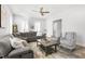 Bright living room with a gray sectional, two armchairs, and a coffee table atop a stylish rug at 200 Gravel Brook Ct, Cary, NC 27519