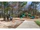 A colorful playground in a park-like setting, featuring slides, climbing structures, and a train at 200 Gravel Brook Ct, Cary, NC 27519