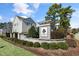 The Willow Oak community entrance featuring a stone wall, sign, and well-maintained landscaping at 200 Gravel Brook Ct, Cary, NC 27519