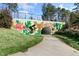 Community tunnel in Cary, NC, featuring vibrant mural art and a paved walkway through manicured greenery at 200 Gravel Brook Ct, Cary, NC 27519