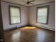 Bedroom with hardwood floors, ceiling fan, and natural light coming in through two windows at 210 E Elk St, Siler City, NC 27344