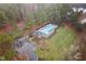 Aerial view of community pool, parking and bath house surrounded by lush trees at 2114 Frissell Ave, Apex, NC 27502