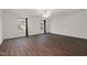 Spacious bedroom with dark hardwood floors, two windows, and ceiling fan at 2114 Frissell Ave, Apex, NC 27502