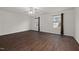 View of a bright bedroom with hardwood floors, two windows, ceiling fan and neutral paint at 2114 Frissell Ave, Apex, NC 27502