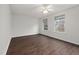 Empty bedroom with hardwood floors, ceiling fan, and plenty of natural light offers a cozy and modern feel at 2114 Frissell Ave, Apex, NC 27502