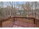 View from the wooden deck showing backyard trees, a playhouse and neighborhood homes at 2114 Frissell Ave, Apex, NC 27502