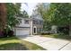 Charming two-story home featuring vinyl and brick siding, an attached garage, and a spacious driveway at 2114 Frissell Ave, Apex, NC 27502