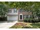 Charming two-story home with brick and vinyl siding, landscaped yard, and a two car garage at 2114 Frissell Ave, Apex, NC 27502
