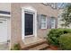 Close up of a brick home with a front door, manicured bushes and shuttered windows at 2114 Frissell Ave, Apex, NC 27502