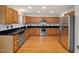 Charming kitchen with stainless steel appliances, wooden cabinets, and granite countertops at 2114 Frissell Ave, Apex, NC 27502