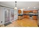 Bright kitchen features wood cabinets, stainless steel appliances, granite countertops, and access to the deck at 2114 Frissell Ave, Apex, NC 27502