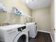 Laundry room with samsung washer and dryer, shelving and hardwood flooring at 2114 Frissell Ave, Apex, NC 27502