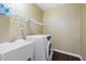 Laundry room featuring samsung dryer, utility sink, shelves and hardwood flooring at 2114 Frissell Ave, Apex, NC 27502