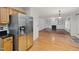 Open-concept living room with hardwood floors and a fireplace with built-in shelving presents a welcoming atmosphere at 2114 Frissell Ave, Apex, NC 27502
