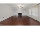 Cozy living room with fireplace, built-in shelving, ceiling fan, and large window at 2114 Frissell Ave, Apex, NC 27502