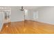 Open-concept living area with hardwood floors, white walls, and view of outdoor living space at 2114 Frissell Ave, Apex, NC 27502