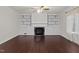 Living room with a fireplace, built-in cabinets, ceiling fan, and a large window at 2114 Frissell Ave, Apex, NC 27502