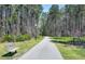 Walking trail through a wooded area with benches along the side at 2114 Frissell Ave, Apex, NC 27502