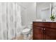 Second bathroom featuring a shower-tub combination, a toilet, and dark wood cabinets at 2117 Mckenzie Ridge Lane Ln, Apex, NC 27502