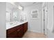 A bright bathroom featuring a double sink vanity, a window, and a large framed mirror at 2117 Mckenzie Ridge Lane Ln, Apex, NC 27502